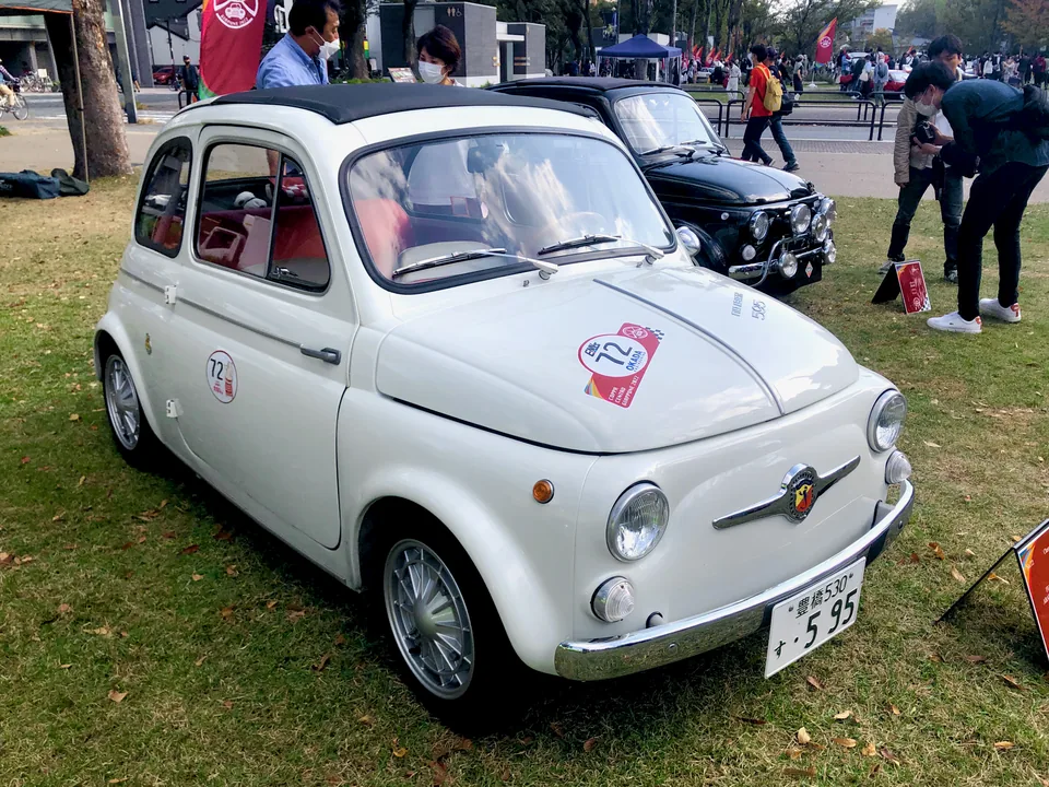 White Fiat-Abarth 595, front three-quarter view, outdoor car show