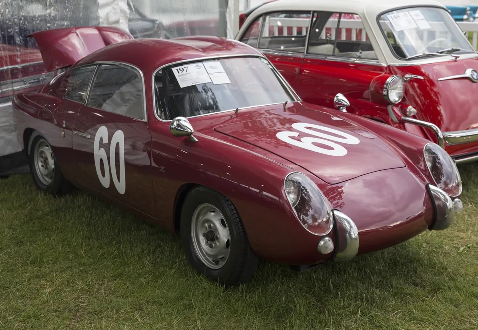 Maroon Fiat-Abarth 750 GT Zagato Double Bubble racing car, front three-quarter view, outdoor car show