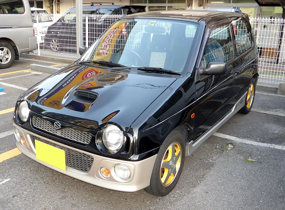 Black Suzuki Alto Works Turbo (HA11S) with bonnet scoop, front three-quarter view