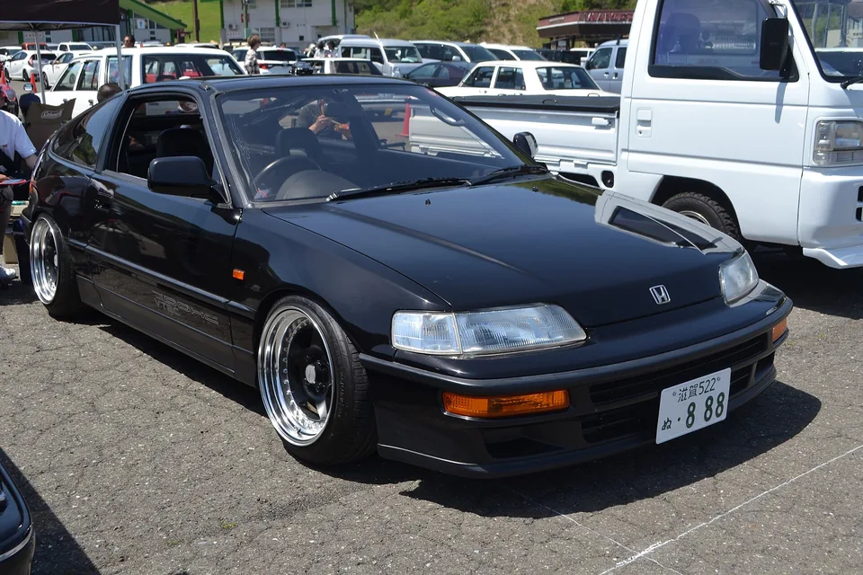 Black Honda CR-X SiR (EF8) on aftermarket wheels, three-quarter front view