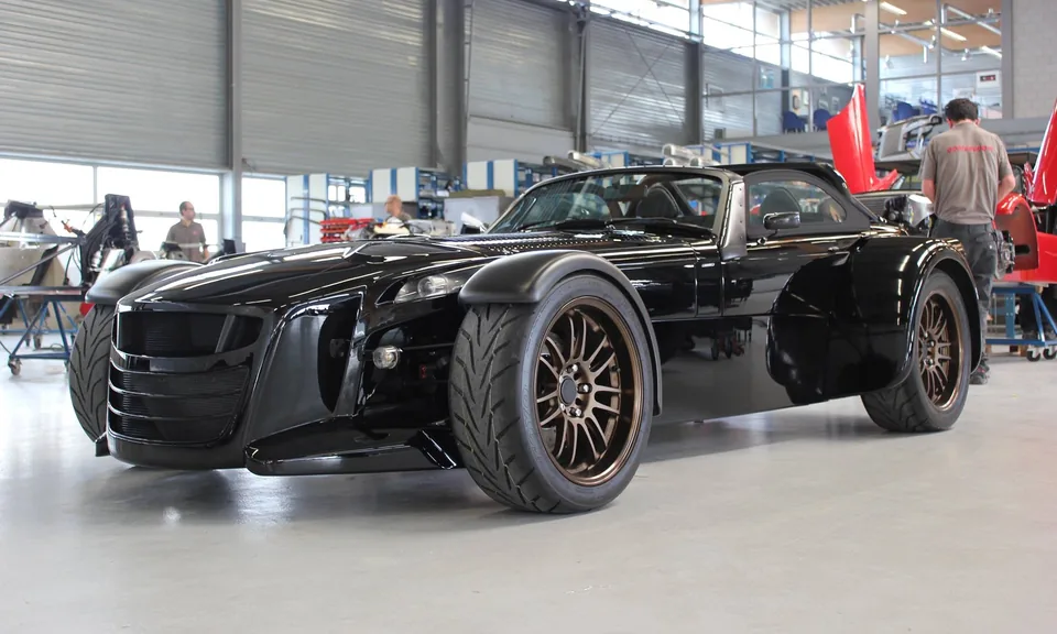 Black Donkervoort D8 GTO at the factory, three-quarter front view