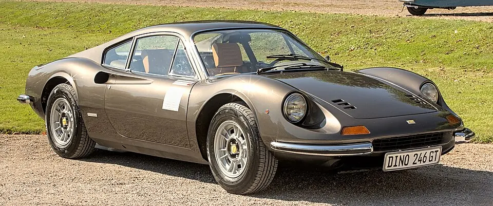 Metallic grey Ferrari Dino 246 GT, front three-quarter view, outdoors