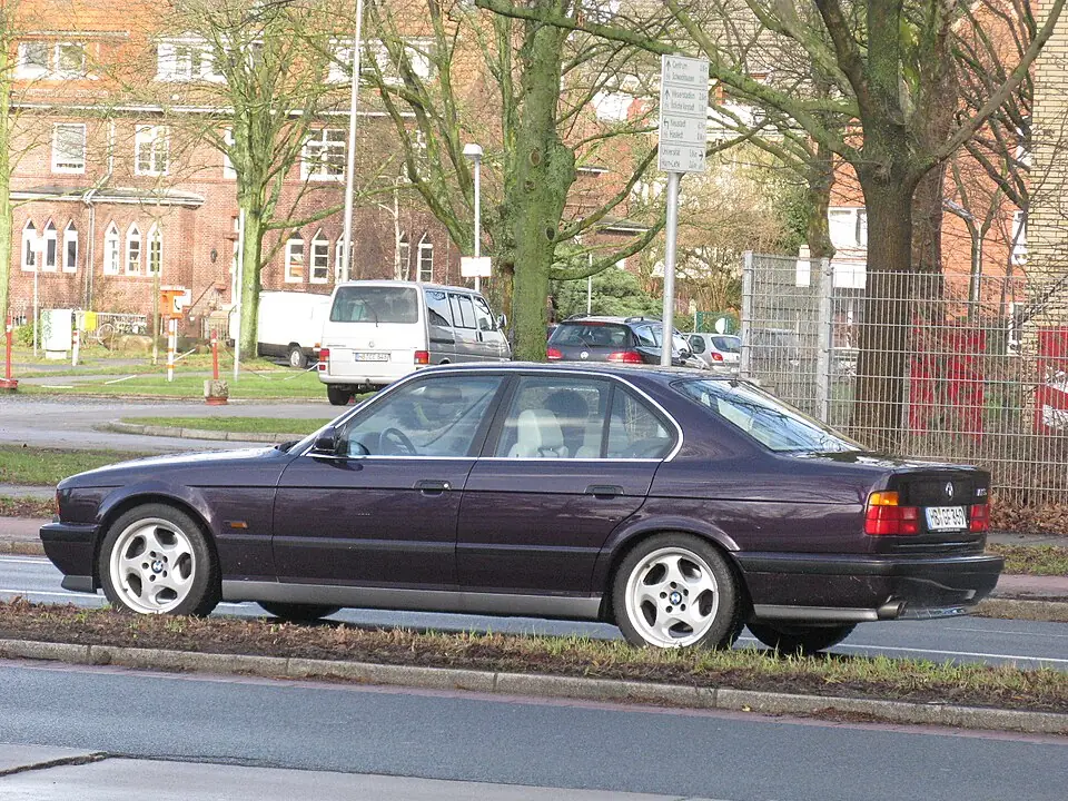 Black BMW M5 E34, three-quarter front view