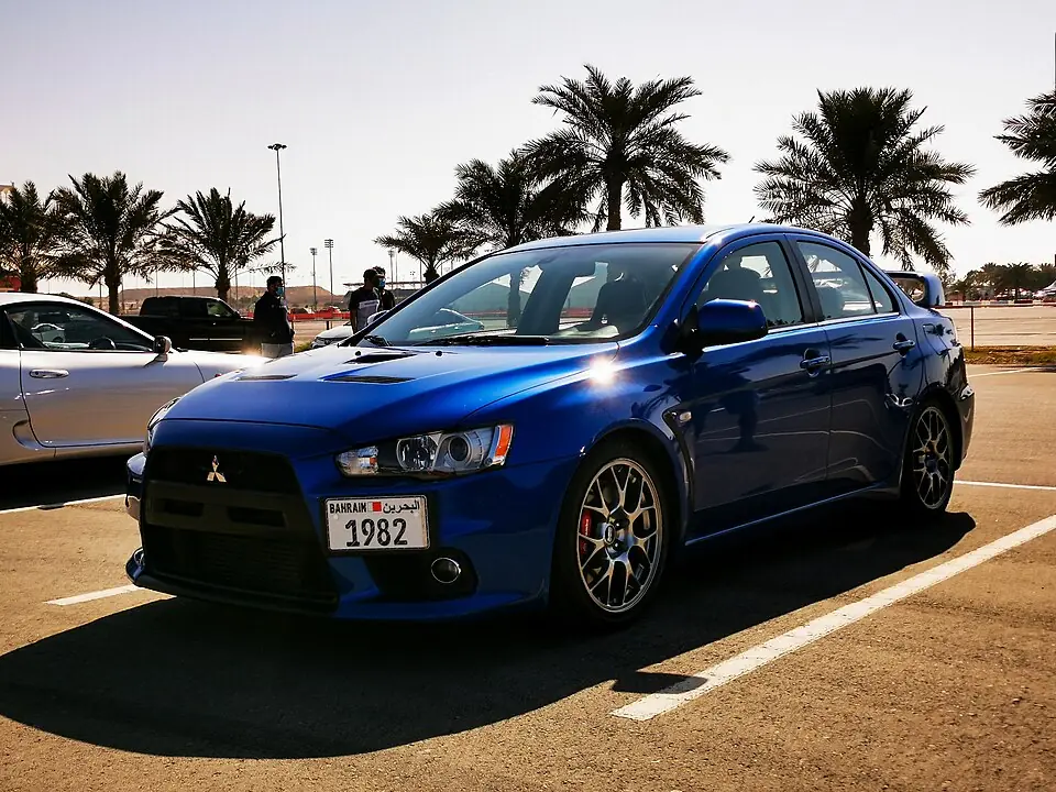 Blue Mitsubishi Lancer Evolution X, three-quarter front view
