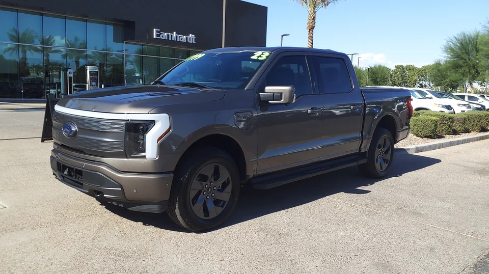 Grey Ford F-150 Lightning Lariat on a dealer lot in Arizona, three-quarter front view