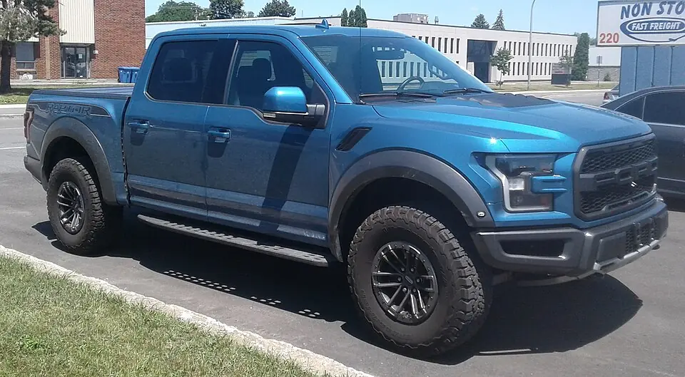 Blue Ford F-150 Raptor, three-quarter front view