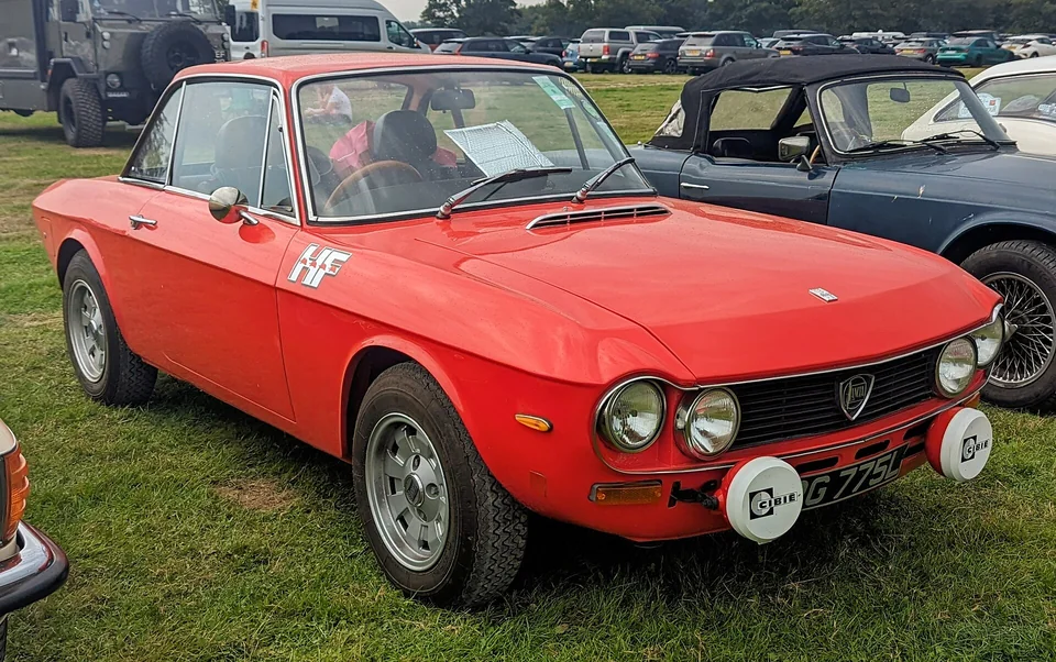 Red Lancia Fulvia Coupé HF with auxiliary lamps, front three-quarter view
