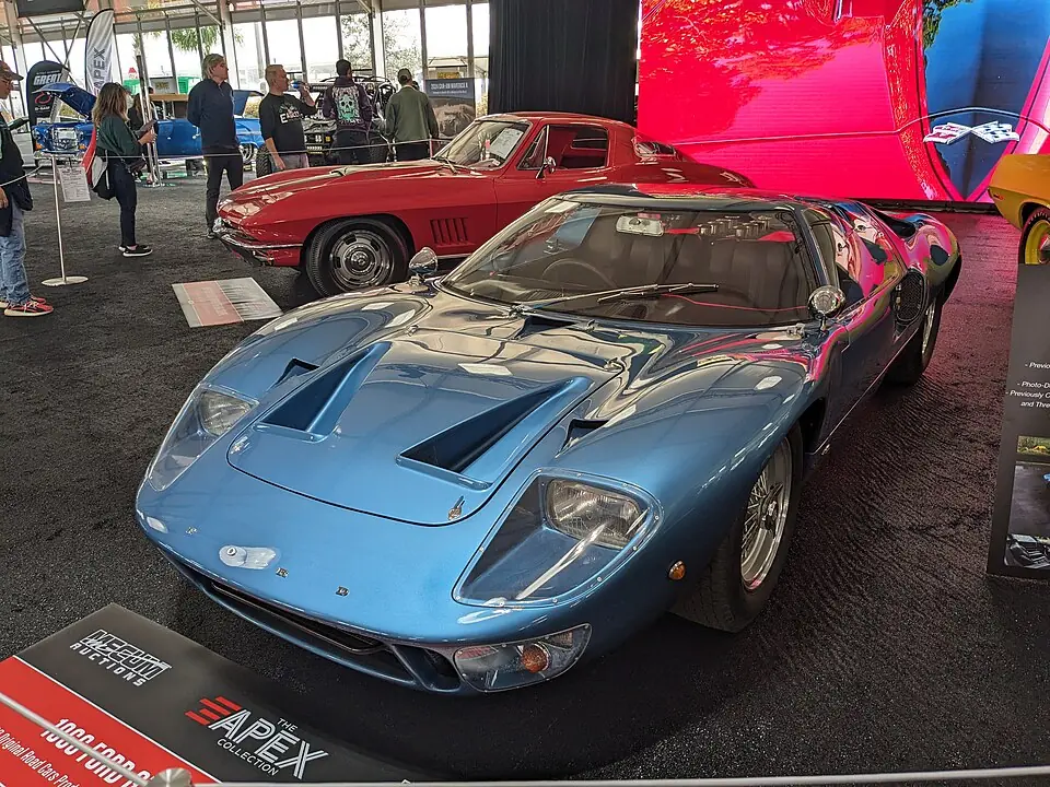 Blue Ford GT40 Mk I road car, front three-quarter view, indoor auto show