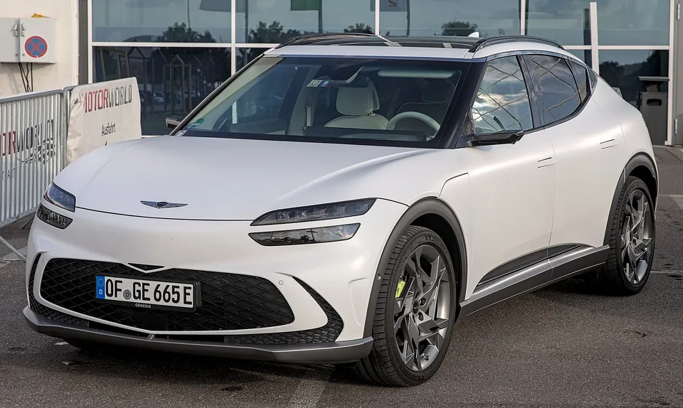 White Genesis GV60 Performance, front three-quarter view