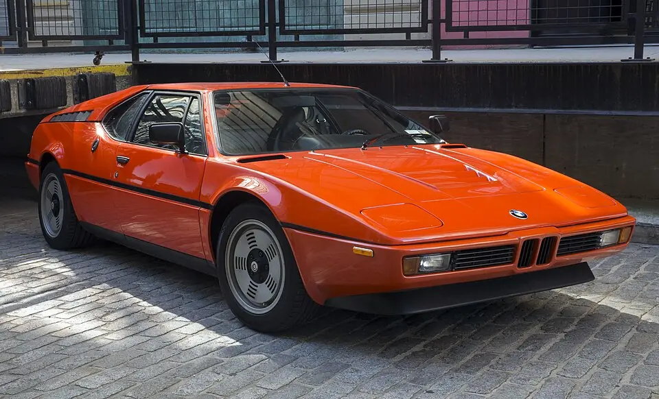 Orange BMW M1 (E26), three-quarter front view