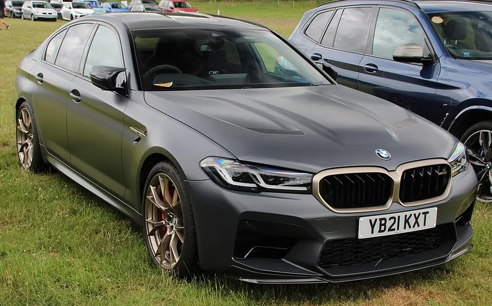Green BMW M5 CS F90, three-quarter front view