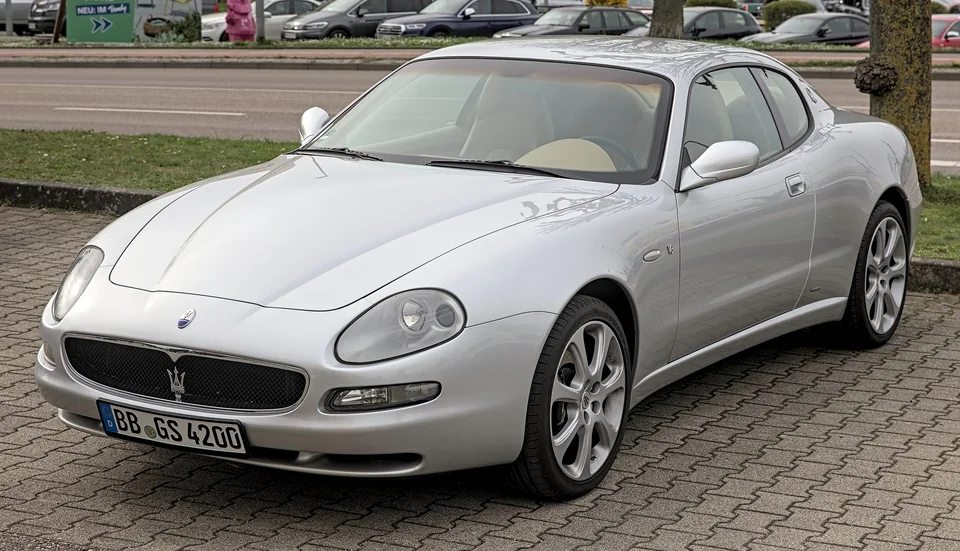 Silver Maserati Coupé parked at a German roadside, three-quarter front view