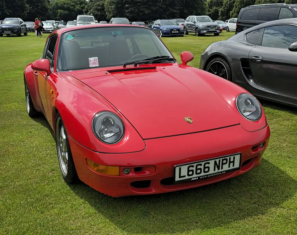 Red Porsche 911 Carrera (993), three-quarter front view