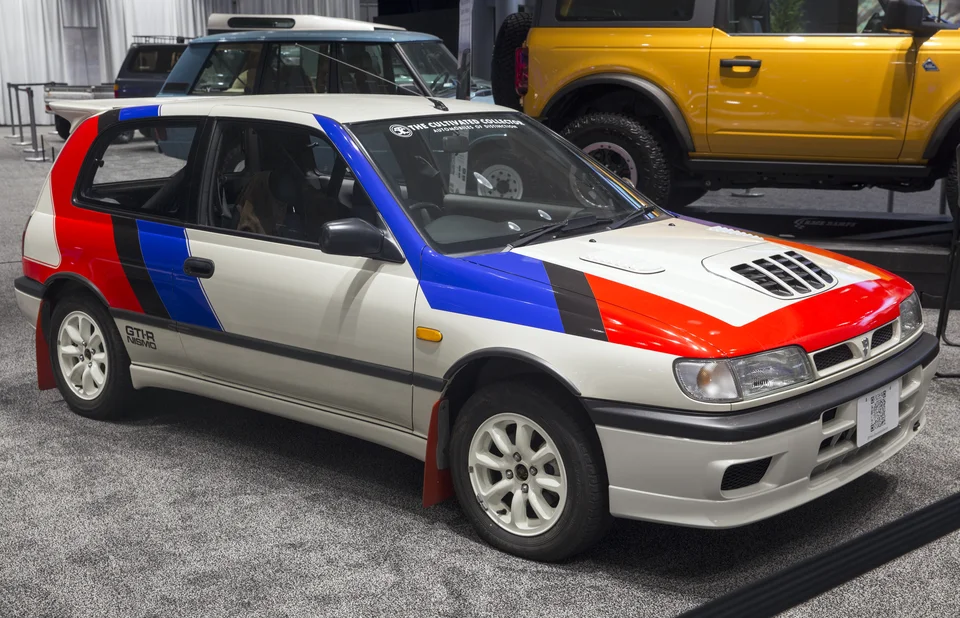 White Nissan Pulsar GTI-R with NISMO livery, three-quarter front view