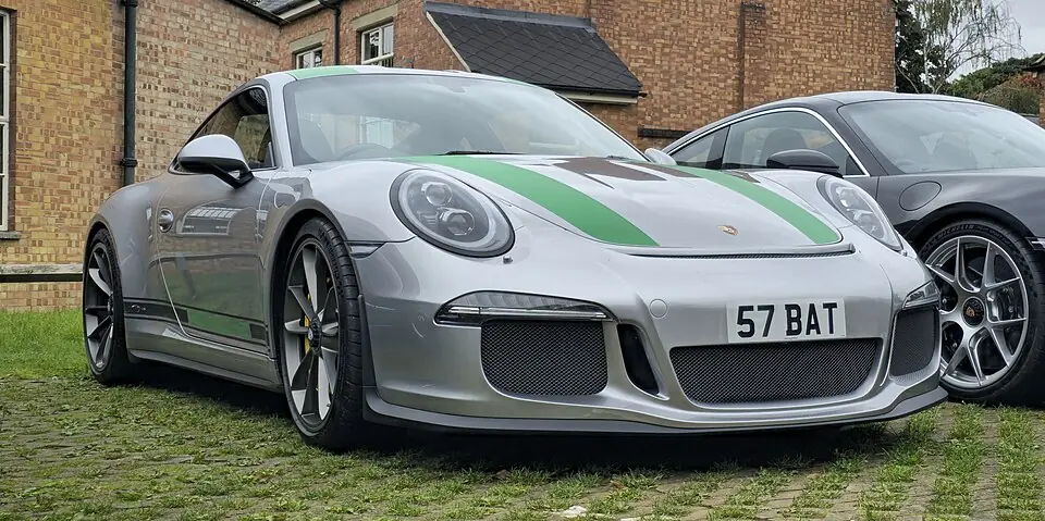 Silver Porsche 911 R with green stripes, three-quarter front view
