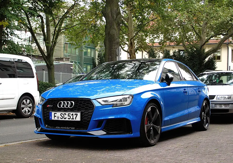 Blue Audi RS3 sedan, three-quarter front view