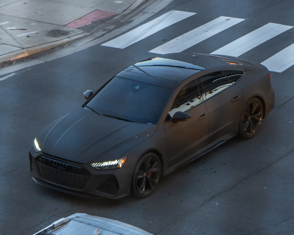 Dark grey Audi RS7 Sportback, elevated three-quarter front view