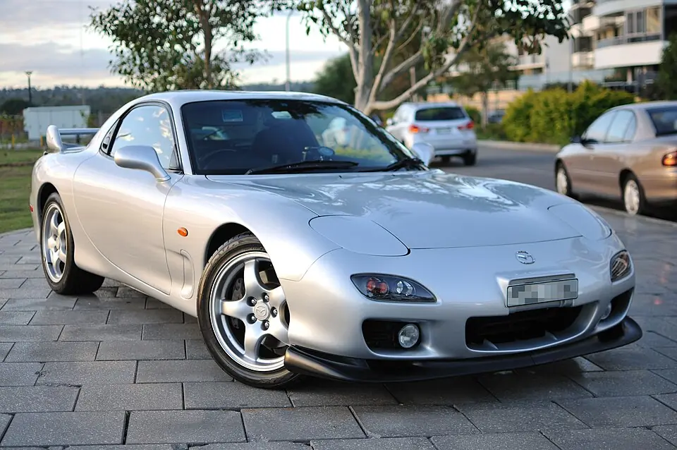 Yellow Mazda RX-7 FD, three-quarter front view