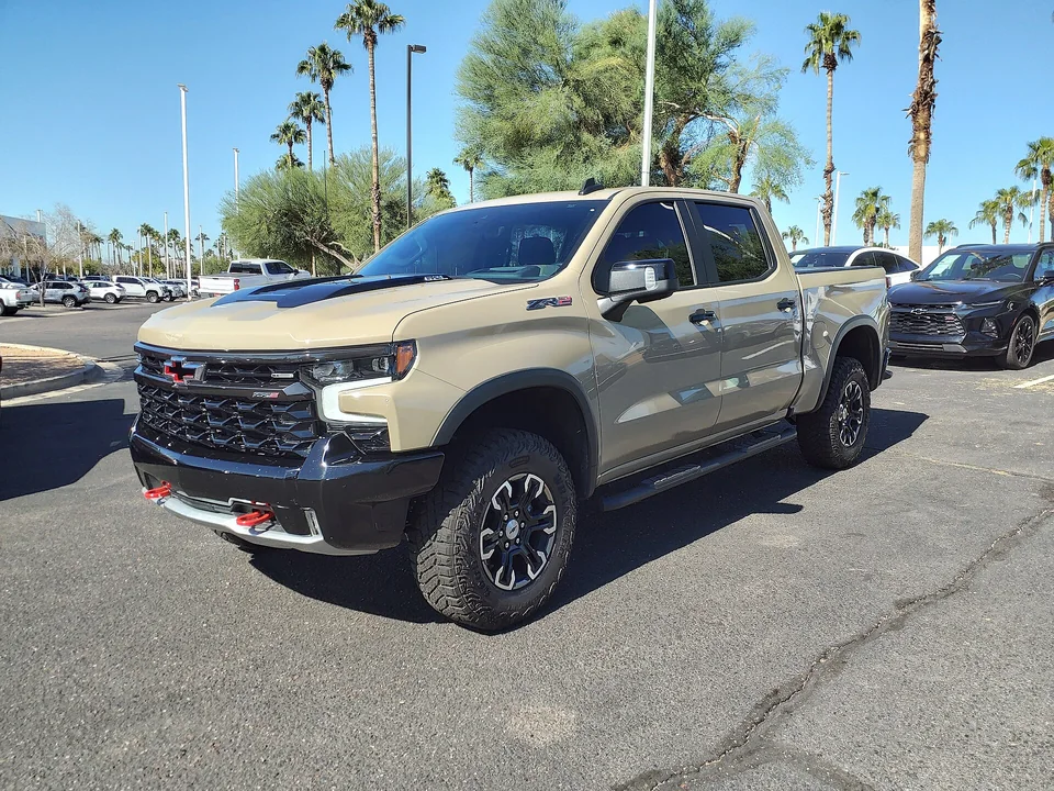 Sand-coloured Chevrolet Silverado 1500 ZR2 on an Arizona dealer lot, three-quarter front view