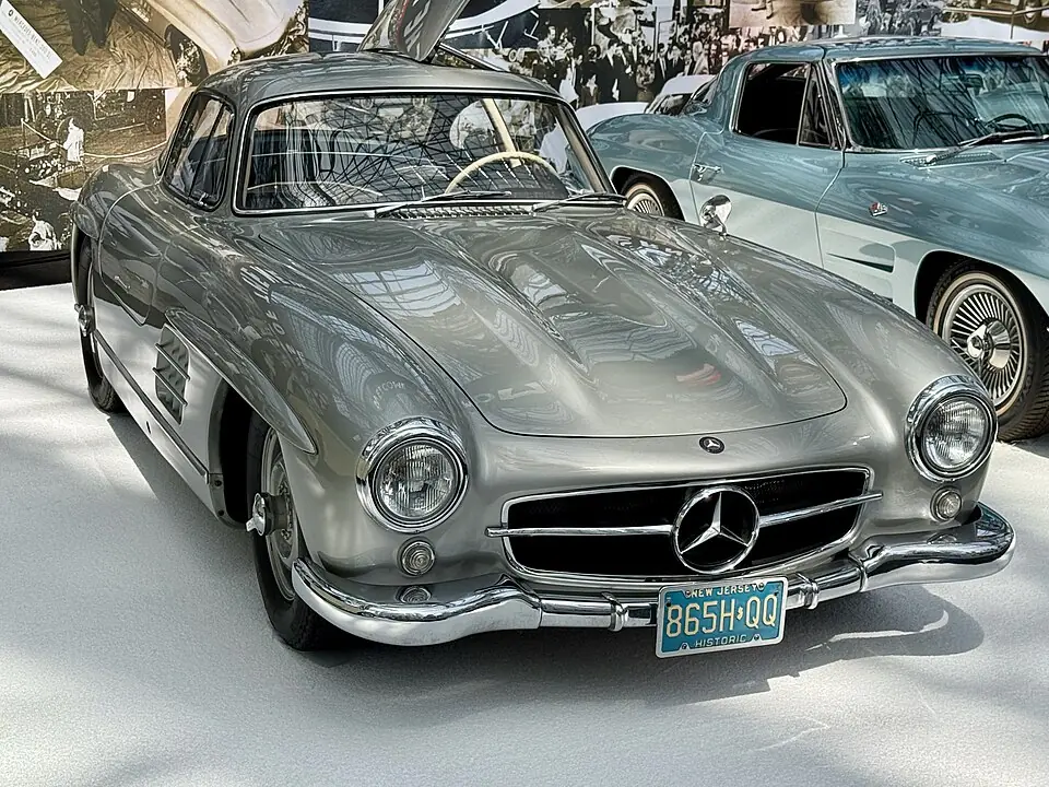 Silver Mercedes-Benz 300SL Gullwing with doors open, front three-quarter view