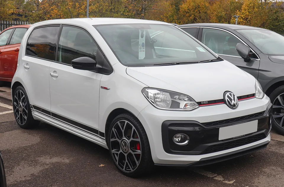White Volkswagen up! GTI, three-quarter front view