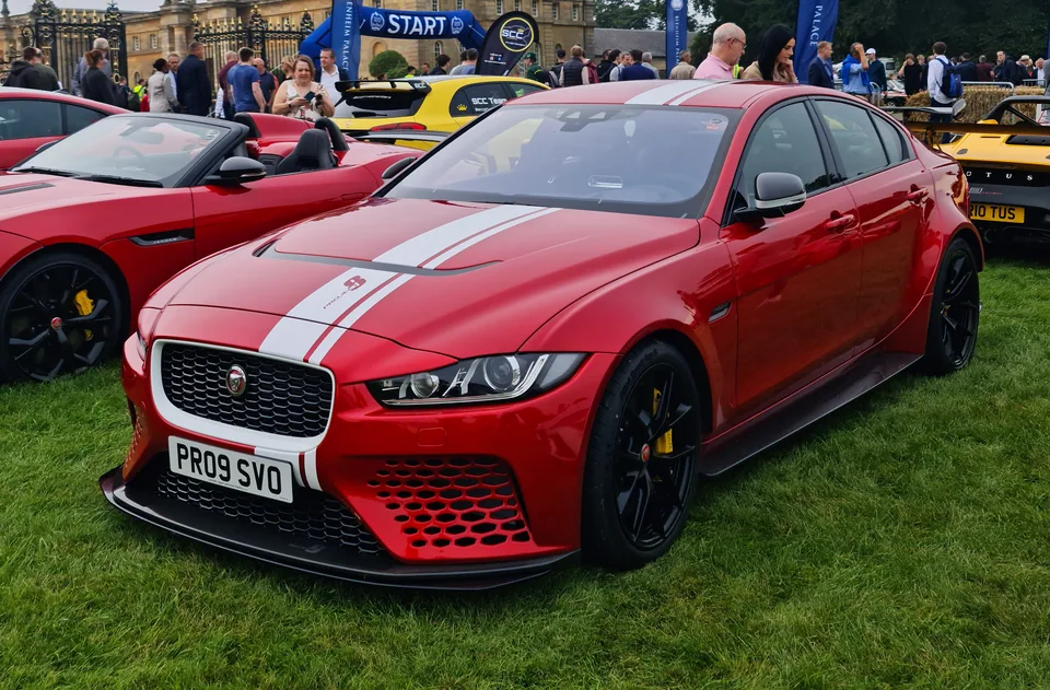 Red Jaguar XE SV Project 8 with white racing stripe, three-quarter front view